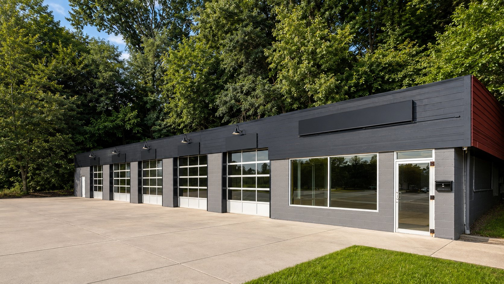 The Parkersburg shop building at 3200 Murdoch Avenue — five glass bay doors and a charcoal exterior