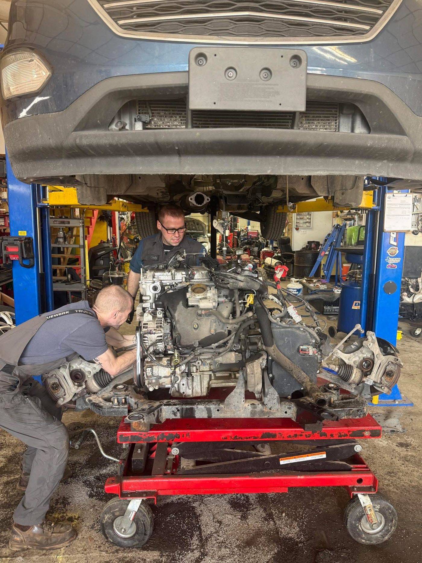 Neff's technicians installing an engine at the New Martinsville shop